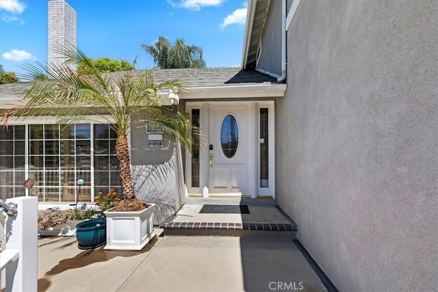 1110 Norcrest St, Corona, CA 92878 - view of exterior entry with a chimney and stucco siding