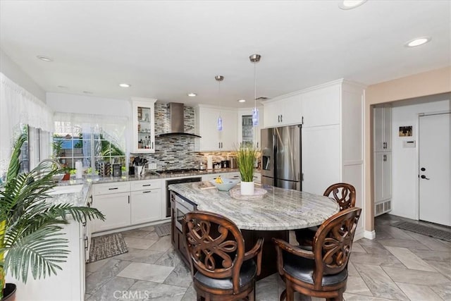 1110 Norcrest St, Corona, CA 92878 - kitchen with wall chimney range hood, stainless steel appliances, a center island, light stone countertops, and white cabinets