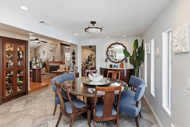 1110 Norcrest St, Corona, CA 92878 - dining area with a fireplace with raised hearth, a ceiling fan, and recessed lighting