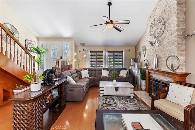 1110 Norcrest St, Corona, CA 92878 - living area with a ceiling fan, lofted ceiling, hardwood / wood-style flooring, stairs, and a stone fireplace