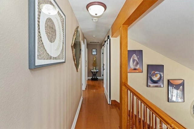 1110 Norcrest St, Corona, CA 92878 - hallway featuring a barn door and wood finished floors