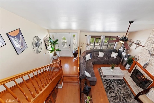 1110 Norcrest St, Corona, CA 92878 - living area with hardwood / wood-style floors, ceiling fan, stairway, and a brick fireplace