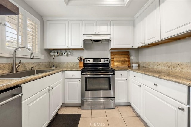 26925 Jasper Unit 210, Mission Viejo, CA 92691 - kitchen featuring appliances with stainless steel finishes, under cabinet range hood, light tile patterned floors, white cabinets, and ornamental molding