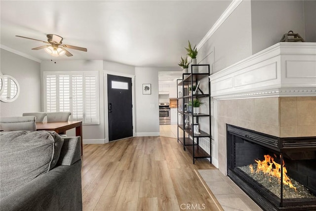 26925 Jasper Unit 210, Mission Viejo, CA 92691 - foyer with light wood-style floors, a ceiling fan, a tile fireplace, and ornamental molding