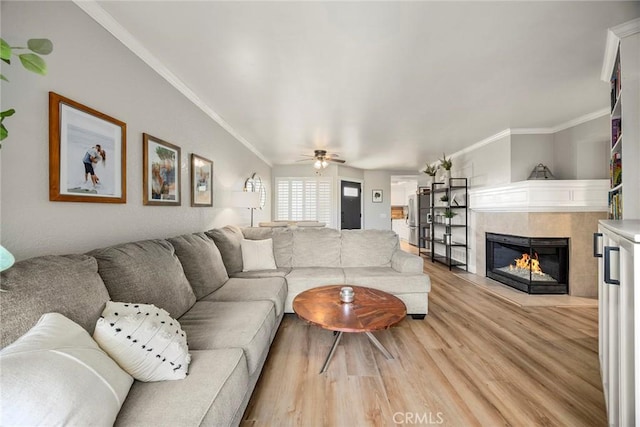 26925 Jasper Unit 210, Mission Viejo, CA 92691 - living area with light wood-type flooring, a tile fireplace, ornamental molding, and a ceiling fan