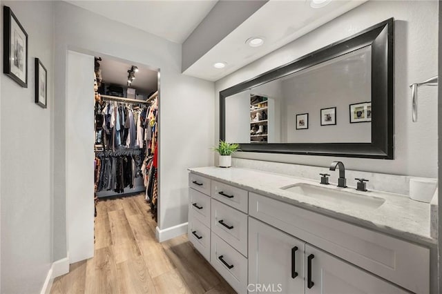 26925 Jasper Unit 210, Mission Viejo, CA 92691 - bathroom with vanity, wood finished floors, a walk in closet, and recessed lighting