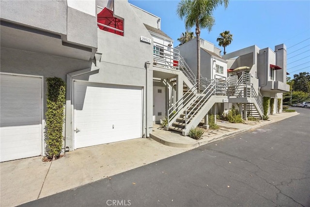 26925 Jasper Unit 210, Mission Viejo, CA 92691 - view of building exterior with stairs, an attached garage, and concrete driveway
