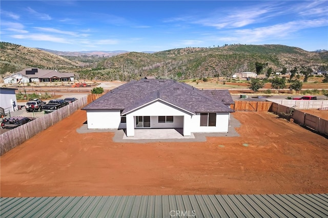 6779 Matell Rd, Paradise, CA 95969 - rear view of house featuring a mountain view, stucco siding, a fenced backyard, and a patio