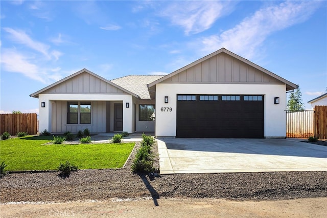 6779 Matell Rd, Paradise, CA 95969 - view of front facade featuring an attached garage, concrete driveway, board and batten siding, a shingled roof, and covered porch