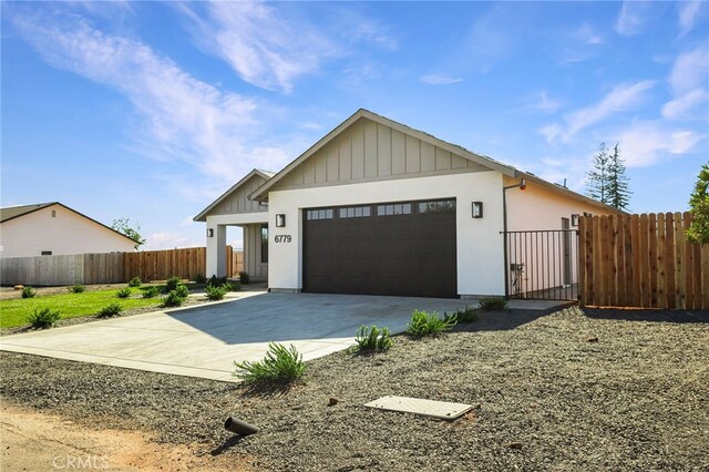 6779 Matell Rd, Paradise, CA 95969 - view of front of property featuring driveway, a garage, a gate, and board and batten siding