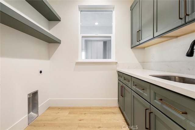 6779 Matell Rd, Paradise, CA 95969 - laundry room featuring light wood-style floors, cabinet space, and hookup for an electric dryer