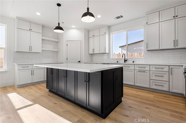 6779 Matell Rd, Paradise, CA 95969 - kitchen featuring open shelves, tasteful backsplash, a kitchen island, light countertops, and recessed lighting