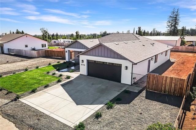 6779 Matell Rd, Paradise, CA 95969 - view of front of home with a shingled roof, a garage, concrete driveway, board and batten siding, and a gate