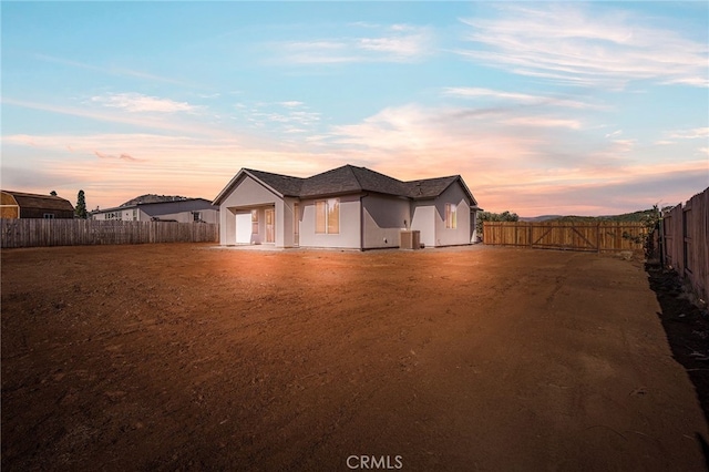 6779 Matell Rd, Paradise, CA 95969 - view of front of property featuring stucco siding, a fenced backyard, an attached garage, and dirt driveway