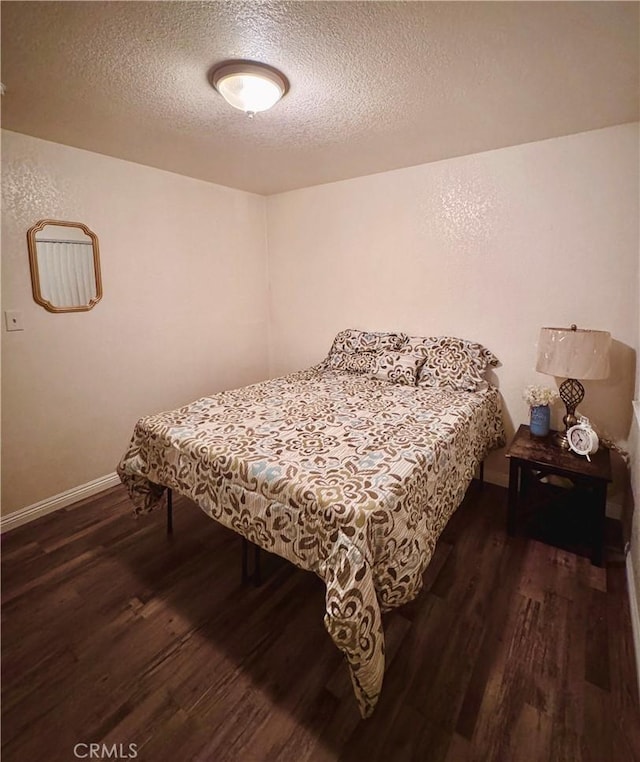 751 Yucca Ave, Barstow, CA 92311 - bedroom with wood finished floors and a textured ceiling