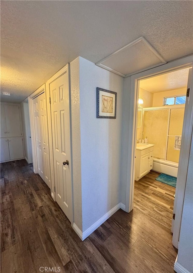751 Yucca Ave, Barstow, CA 92311 - corridor with a textured ceiling and dark wood finished floors