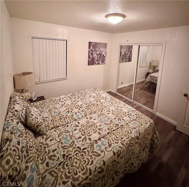 751 Yucca Ave, Barstow, CA 92311 - bedroom featuring a textured ceiling, wood finished floors, and a closet