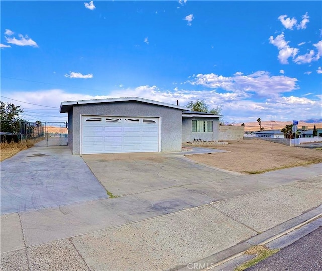 751 Yucca Ave, Barstow, CA 92311 - ranch-style home featuring stucco siding, concrete driveway, and an attached garage