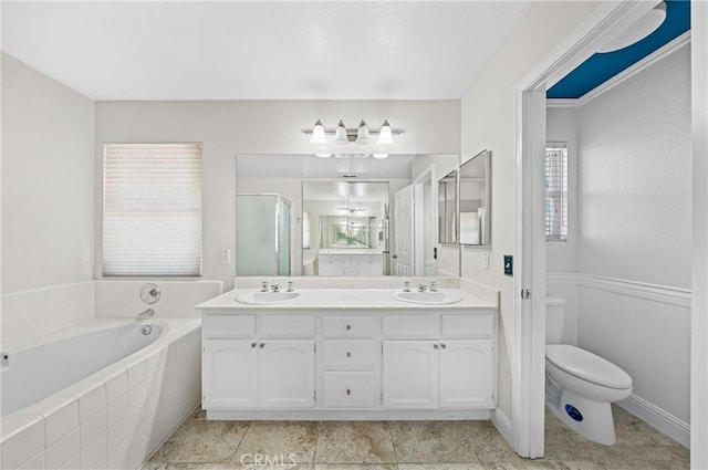 39647 Dartanian Pl, Murrieta, CA 92562 - full bathroom with double vanity, a bath, a stall shower, and wainscoting