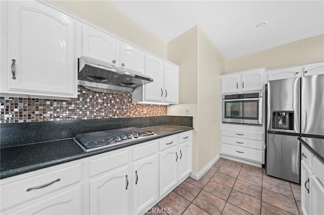 39647 Dartanian Pl, Murrieta, CA 92562 - kitchen with stainless steel appliances, under cabinet range hood, dark countertops, and white cabinets