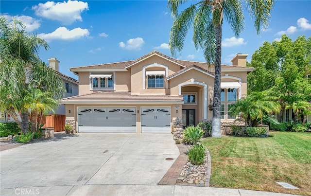 39647 Dartanian Pl, Murrieta, CA 92562 - view of front of home with a garage, stucco siding, concrete driveway, a chimney, and stone siding