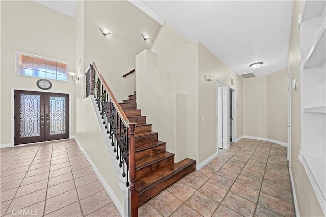 39647 Dartanian Pl, Murrieta, CA 92562 - foyer with french doors, stairway, tile patterned flooring, and a towering ceiling