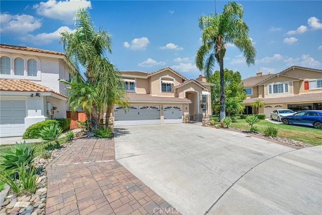 39647 Dartanian Pl, Murrieta, CA 92562 - mediterranean / spanish-style house featuring driveway, stucco siding, an attached garage, and a tiled roof