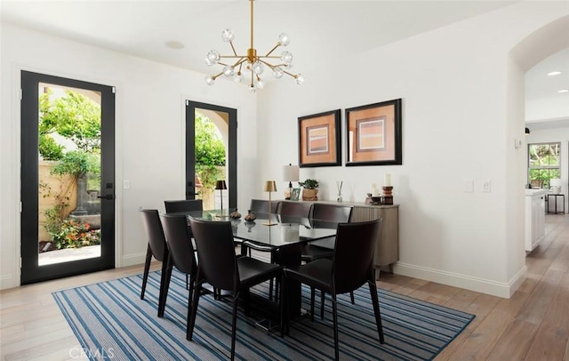 21 Via Nerisa, San Clemente, CA 92673 - dining room featuring light wood-style floors, a chandelier, and arched walkways