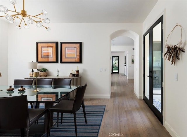 21 Via Nerisa, San Clemente, CA 92673 - dining room with arched walkways, a chandelier, and light wood-style flooring