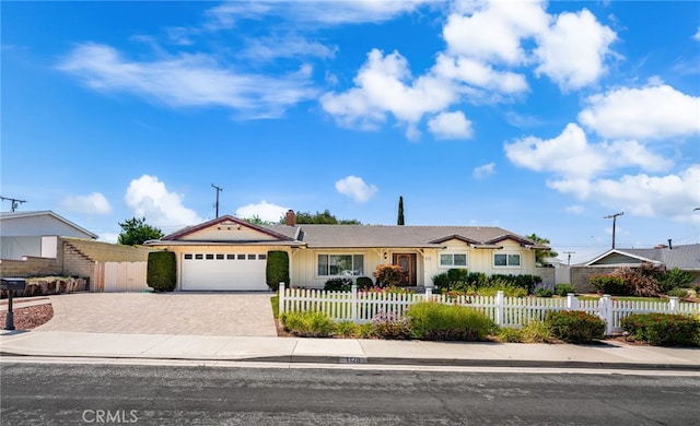 1128 Aldersgate Dr, La Verne, CA 91750 - ranch-style house featuring decorative driveway, a garage, a fenced front yard, and a chimney
