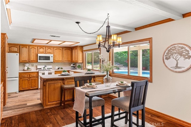 1128 Aldersgate Dr, La Verne, CA 91750 - kitchen with white appliances, beam ceiling, brown cabinetry, light countertops, and wood finished floors