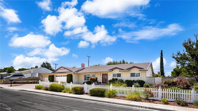 1128 Aldersgate Dr, La Verne, CA 91750 - single story home featuring a garage, driveway, a fenced front yard, a chimney, and board and batten siding