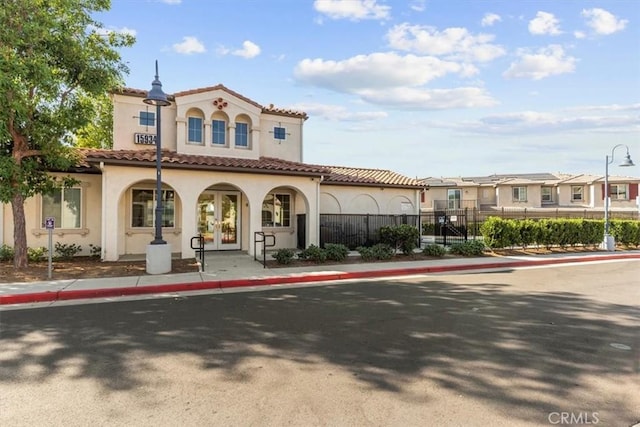 15958 Lasselle St Unit 2, Moreno Valley, CA 92551 - view of front of home with stucco siding, a tiled roof, and french doors