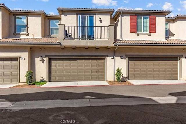 15958 Lasselle St Unit 2, Moreno Valley, CA 92551 - view of property with a balcony, a garage, stucco siding, and a tile roof