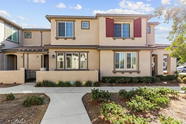 15958 Lasselle St Unit 2, Moreno Valley, CA 92551 - view of front facade with stucco siding, a tiled roof, and a gate