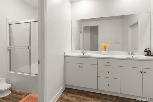 15958 Lasselle St Unit 2, Moreno Valley, CA 92551 - bathroom with double vanity, wood finished floors, and combined bath / shower with glass door
