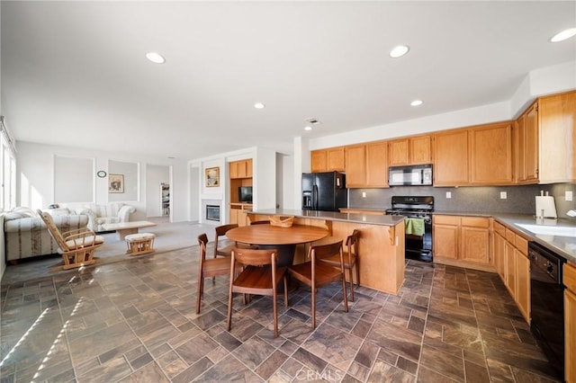 15453 La Casa Dr, Moreno Valley, CA 92555 - kitchen featuring black appliances, open floor plan, a kitchen island, light brown cabinetry, and backsplash