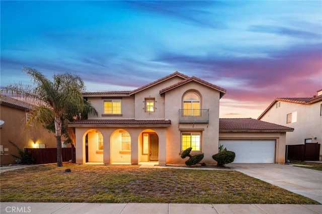 15453 La Casa Dr, Moreno Valley, CA 92555 - mediterranean / spanish house with a balcony, driveway, covered porch, a garage, and stucco siding