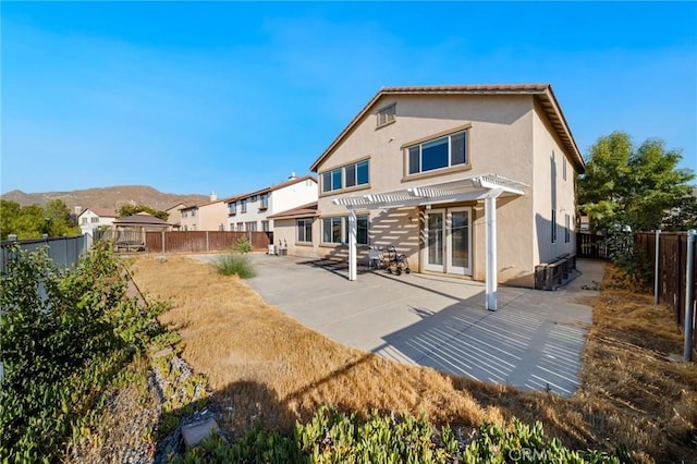 15453 La Casa Dr, Moreno Valley, CA 92555 - rear view of property with a pergola, a fenced backyard, stucco siding, and a patio