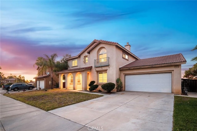 15453 La Casa Dr, Moreno Valley, CA 92555 - mediterranean / spanish-style house featuring a chimney, concrete driveway, stucco siding, and a garage