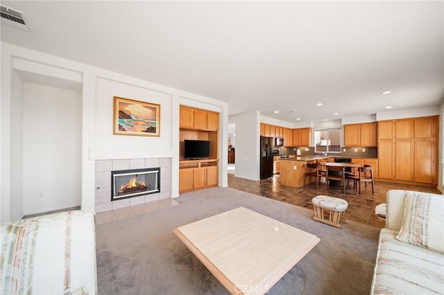 15453 La Casa Dr, Moreno Valley, CA 92555 - living area featuring a tile fireplace, recessed lighting, and carpet floors