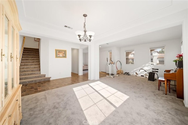 15453 La Casa Dr, Moreno Valley, CA 92555 - carpeted living room with stairs, a chandelier, and a tray ceiling