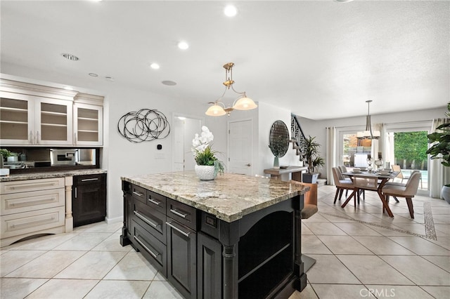 9168 El Azul Cir, Fountain Valley, CA 92708 - kitchen with dark cabinets, light tile patterned flooring, open shelves, decorative light fixtures, and recessed lighting