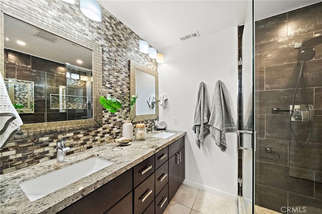 9168 El Azul Cir, Fountain Valley, CA 92708 - bathroom with double vanity, tile patterned floors, a stall shower, and decorative backsplash
