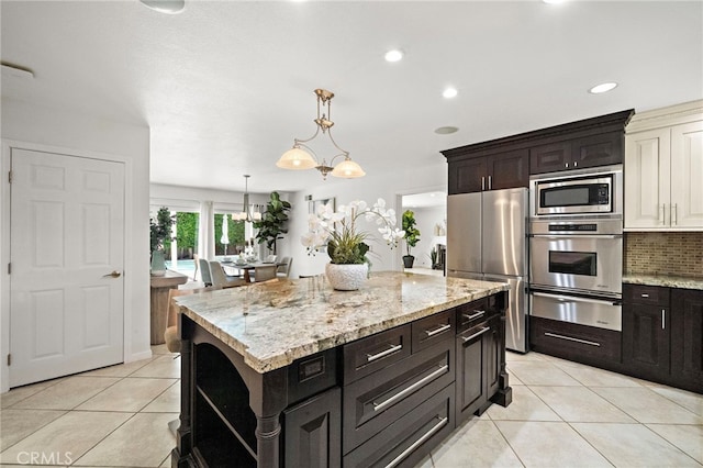9168 El Azul Cir, Fountain Valley, CA 92708 - kitchen featuring appliances with stainless steel finishes, a warming drawer, light tile patterned flooring, light stone counters, and backsplash