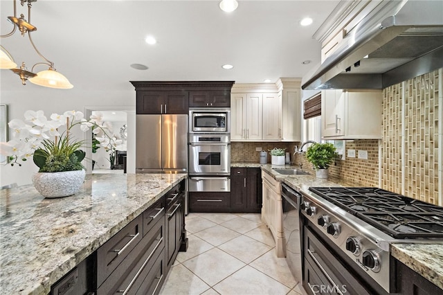 9168 El Azul Cir, Fountain Valley, CA 92708 - kitchen featuring stainless steel appliances, custom range hood, a warming drawer, backsplash, and light stone counters