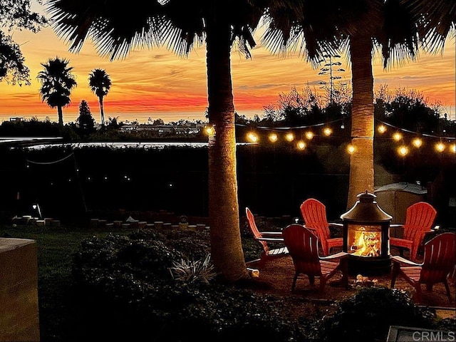 860 Nardo Rd, Encinitas, CA 92024 - patio terrace at dusk featuring an outdoor fire pit
