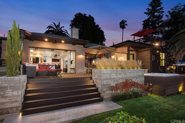 860 Nardo Rd, Encinitas, CA 92024 - back of property at dusk with a chimney, a deck, and stucco siding
