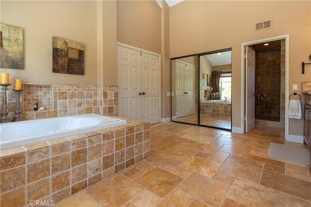 31032 Via Estenaga, San Juan Capistrano, CA 92675 - bathroom with stone tile floors, a bath, and a high ceiling