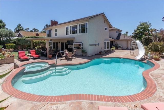 31032 Via Estenaga, San Juan Capistrano, CA 92675 - view of swimming pool featuring a water slide, a patio area, and a pool with connected hot tub